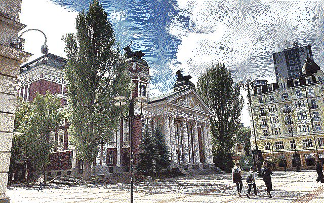 A nicer photo of the National Theater from the side, with some students walking in front