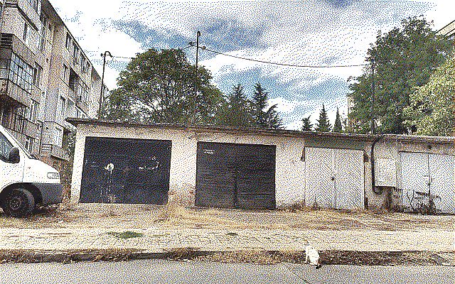 Some parking garages with a cat in front