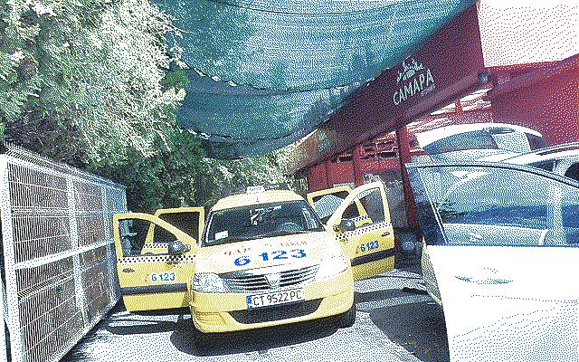 A car wash with a yellow taxi parked out front