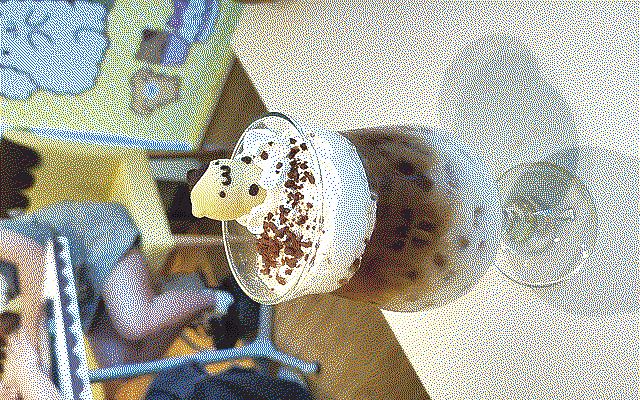 Big chocolate drink with big foam and a small chocolate figurine on top