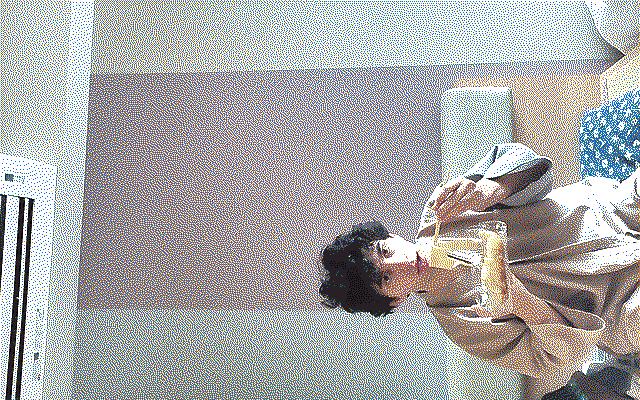 A boy eating noodles in a bathrobe