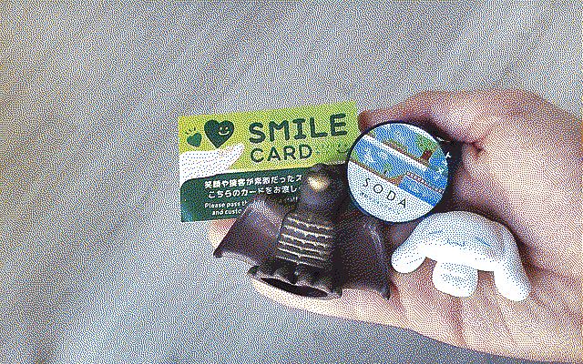 A green card that says “Smile Card,” a washi tape with a video game pattern that says “Soda,” a kaiju and a bunny